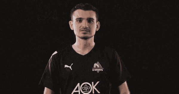 a man wearing a black shirt with aok written on it