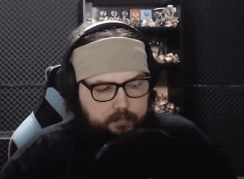 a man wearing headphones and a headband looks down