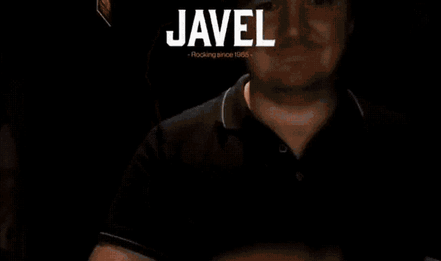 a man in a dark room with the name javel on his head