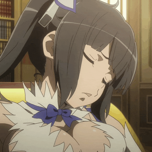 a close up of a girl with her eyes closed and a blue bow around her neck