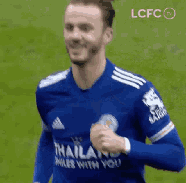 a soccer player wearing a blue jersey is running on the field .