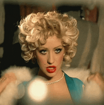 a woman with blonde curly hair and red lipstick
