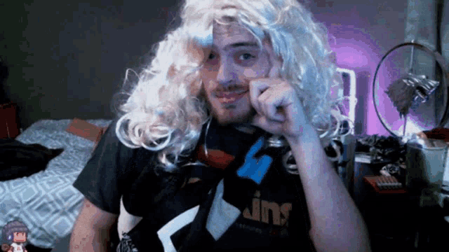 a man wearing a wig and a jins shirt