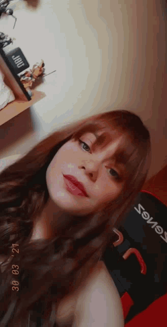 a woman taking a selfie with the date 30 03 21 on the bottom