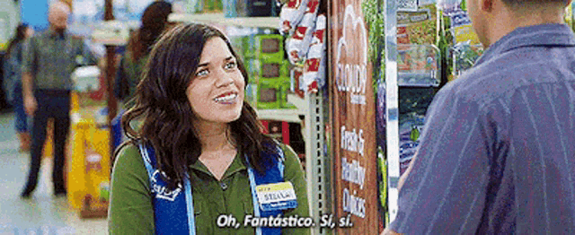 a woman is talking to a man in a grocery store .