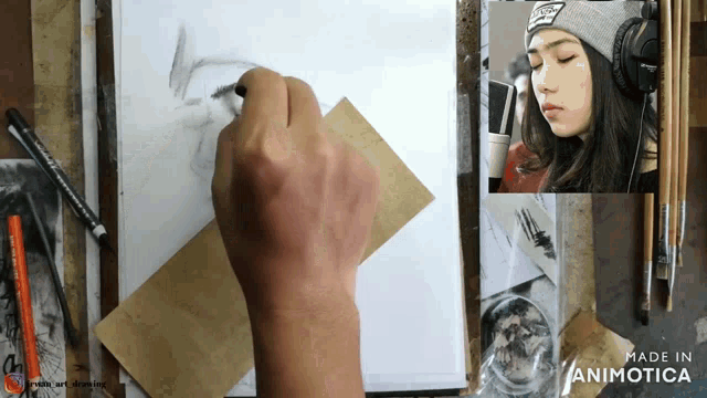 a person is drawing a woman 's face and the words made in animatica are on the bottom
