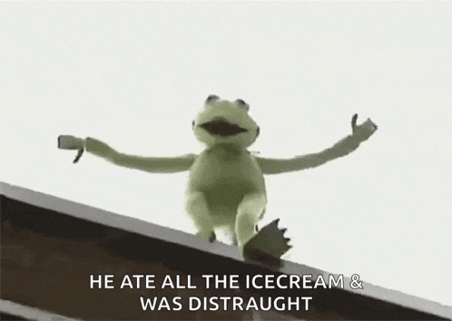 kermit the frog is sitting on top of a building .