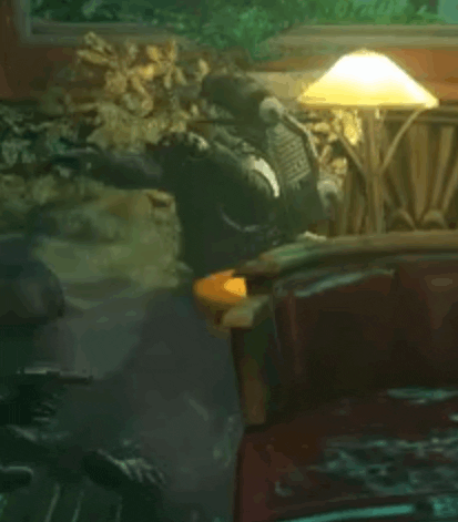 a person is sitting on a couch in a dark room with a lamp .