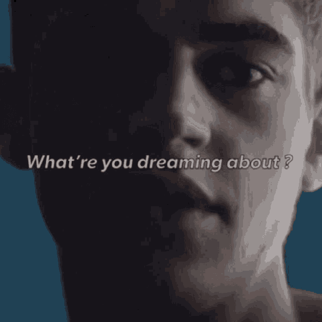 a close up of a man 's face with the words " what 're you dreaming about " written above him .