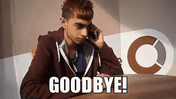 a young man is sitting at a table talking on a cell phone and says goodbye .