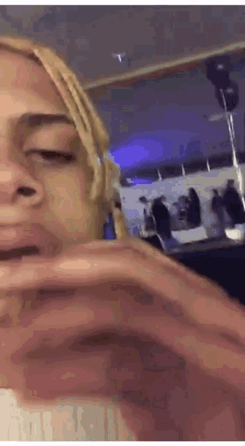 a close up of a person 's face with a blue light behind them