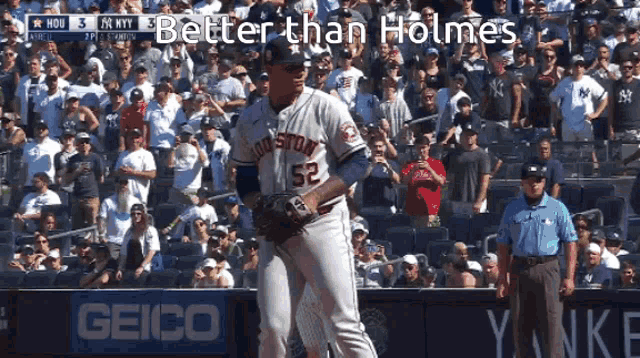 a baseball player with the number 52 on his jersey stands on the field