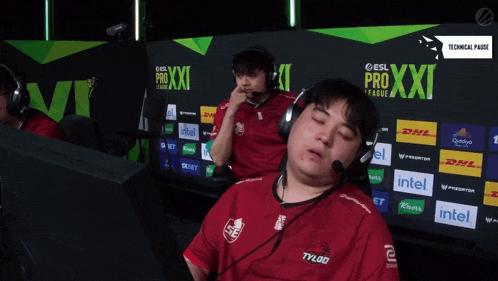 a man wearing headphones stands in front of a wall that says pro xxi league
