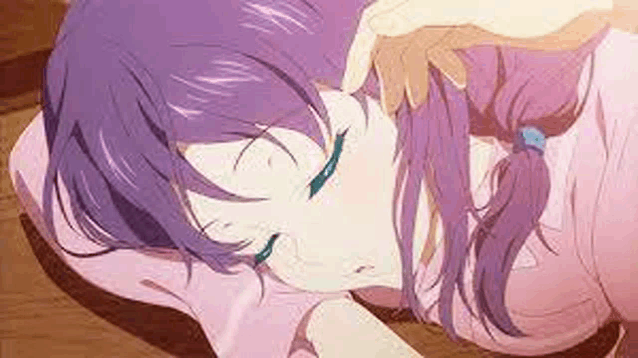 a girl with purple hair is laying on a bed with her eyes closed .