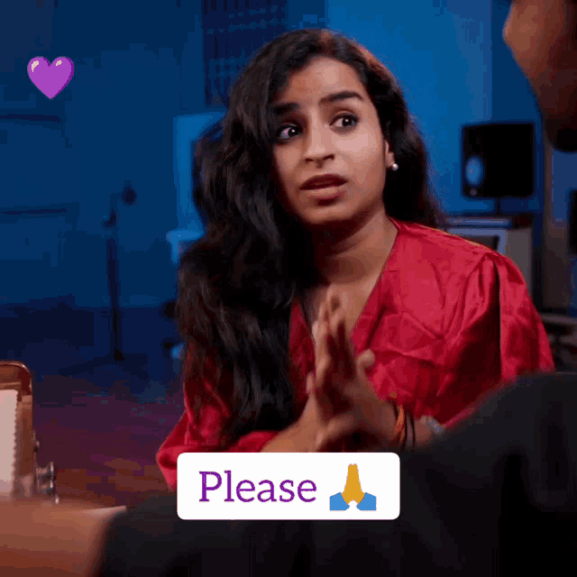 a woman in a red robe with a please sticker