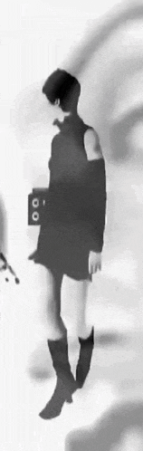 a black and white photo of a woman in a short dress