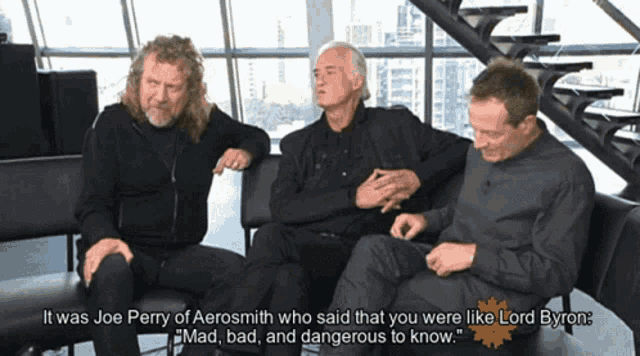 three men are sitting on a couch and one of them says it was joe perry of aerosmith