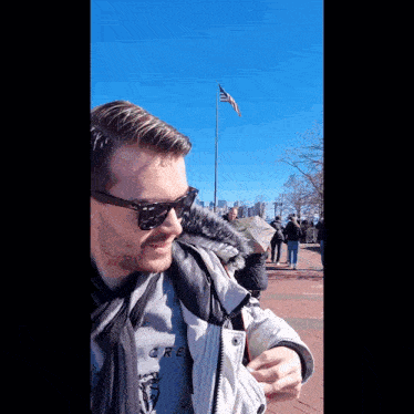 a man wearing sunglasses and a shirt that says crew on it