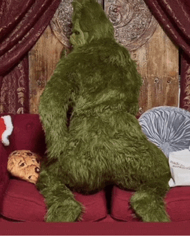 a stuffed animal is sitting on a red couch