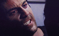 a close up of a man 's face with a smile on it