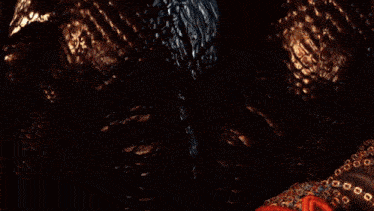 a close up of a person holding a sword in a dark room .