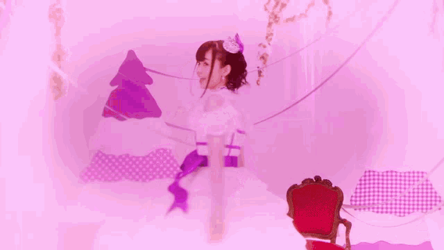 a girl in a white dress with a purple ribbon around her neck