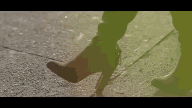 a woman wearing a pair of high heeled boots