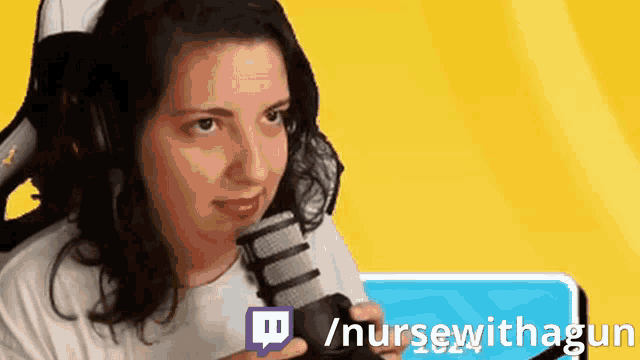 a woman is wearing headphones and holding a microphone in front of a yellow background that says / nursewithagun
