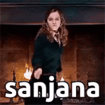 a woman is standing in front of a fireplace holding a sword and the word sajana is on the bottom .