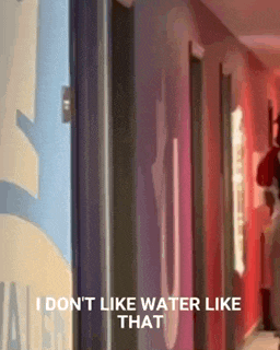 a person standing in a hallway with the words i don t like water like that
