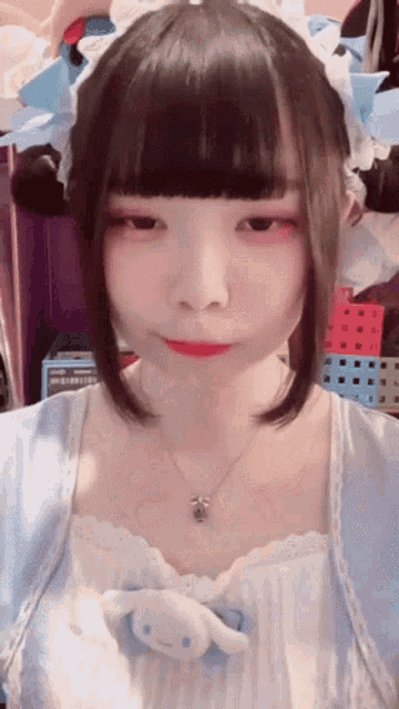 a girl wearing a blue and white dress with a necklace