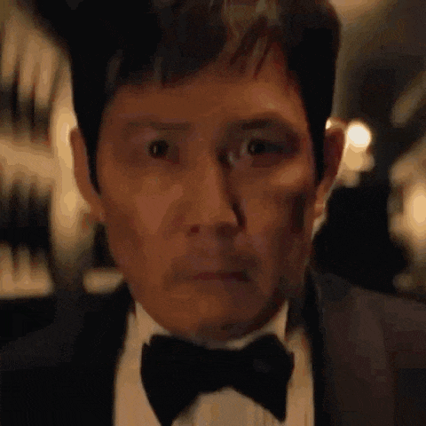 a close up of a man in a suit and bow tie .