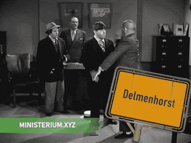 a sign that says delmenhorst on it in front of some men