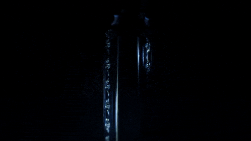 a vampire is laying in a coffin with his mouth open .