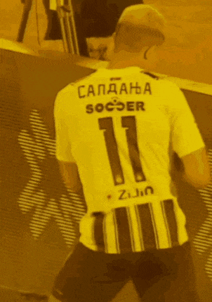 a man wearing a soccer jersey with the number 11