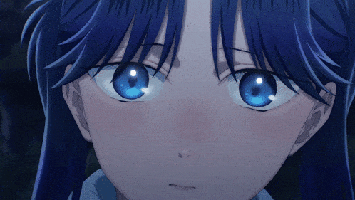 a close up of a girl with blue eyes