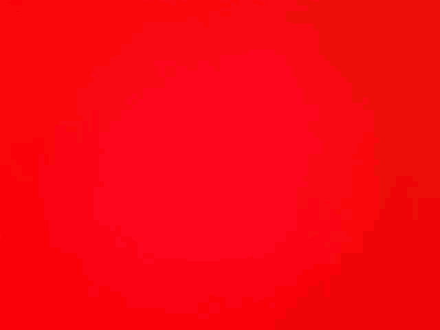 a close up of a red background that looks like a plain red background .