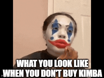 a woman is wearing a clown mask and applying makeup .