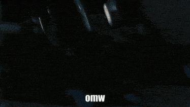 a man in a suit is looking up with the word omw above him