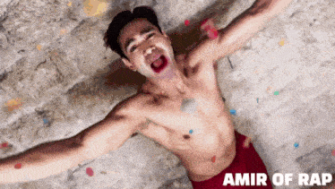 a shirtless man with his arms outstretched and the words amir of rap written below him