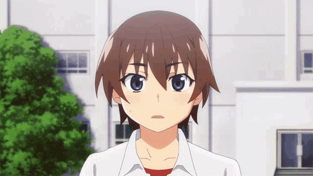 a young boy with brown hair and blue eyes stands in front of a building