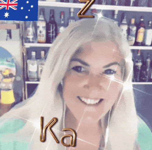 a woman is smiling in front of a british flag and bottles