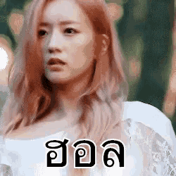 a woman with red hair is wearing a white dress with a foreign language on it .