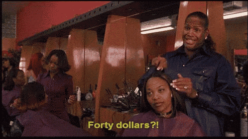 a man is giving a woman a haircut and says forty dollars ?