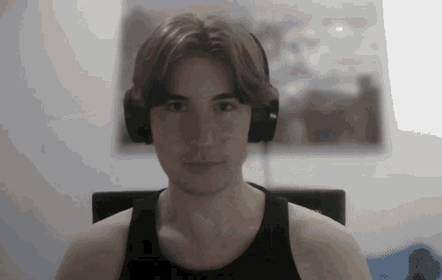 a man wearing headphones looks at the camera