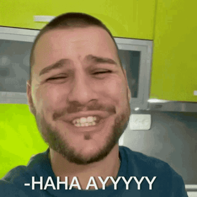 a man with a beard is making a funny face with the words -haha ayyyy below him