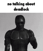 a man in a black suit is standing in front of a white background with the words `` no talking about deadlock '' .