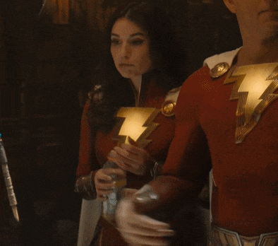 a man and a woman in superhero costumes drinking from a bottle