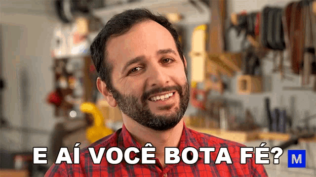 a man with a beard is smiling and says e ai voce bota fe m