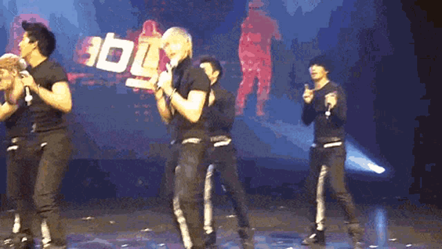 a group of men are dancing on a stage in front of a jbl logo